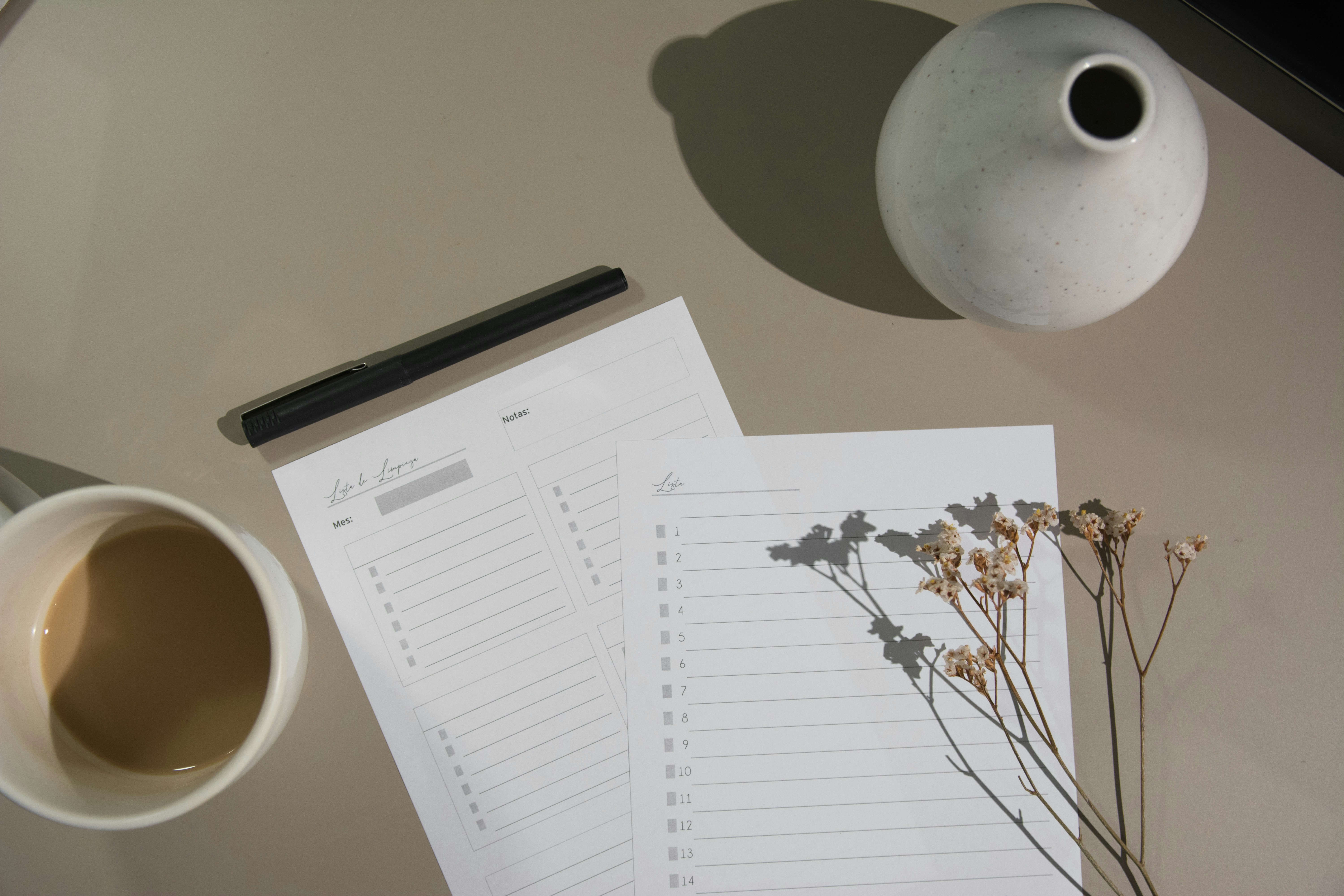 Notebook, pen, and coffee for calm weekly planning with Listvik
